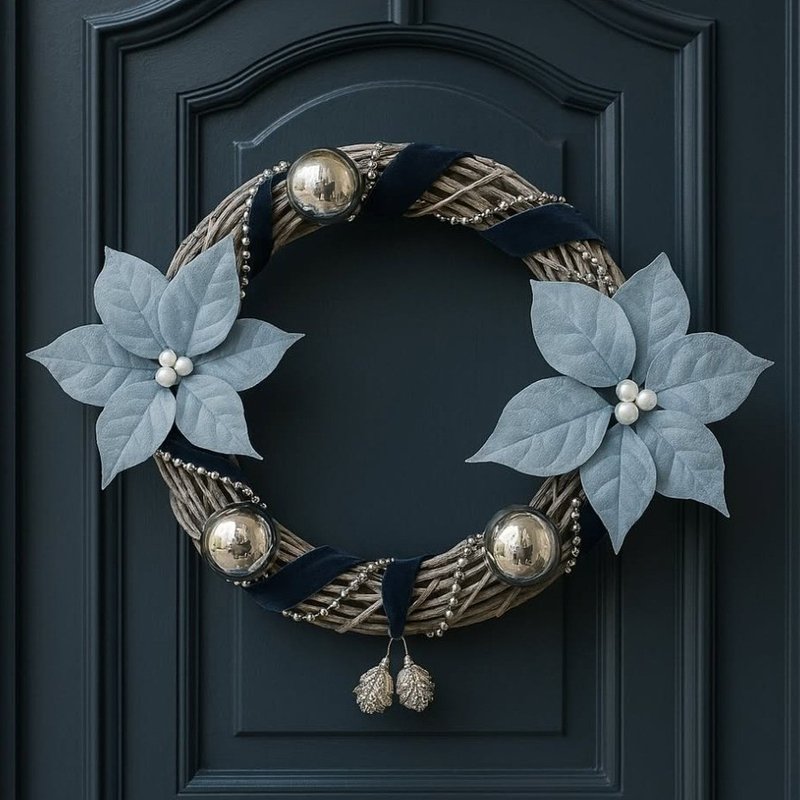 Grapevine wreath with navy velvet ribbon, silver ornaments and dusty blue poinsettias